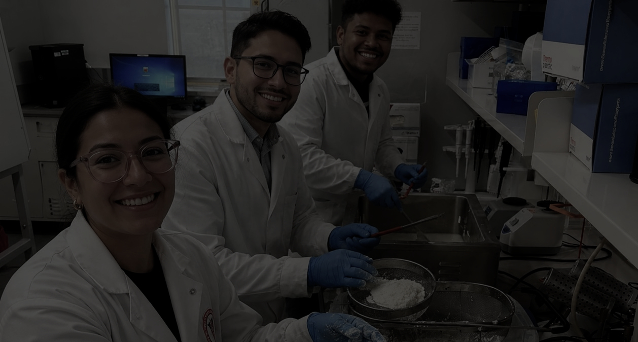 3 students smiling in microbiology lab